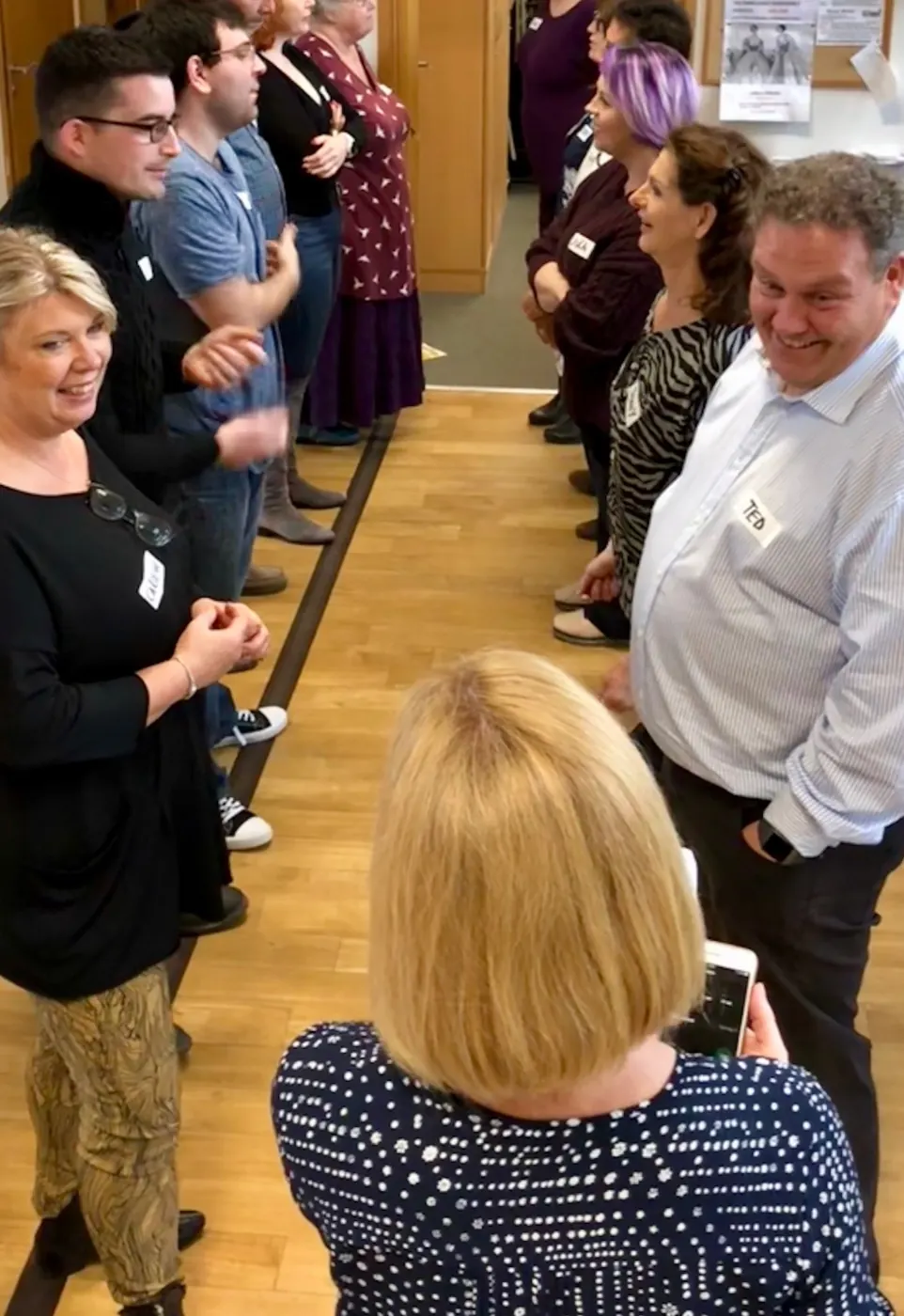 Emotional Fitness Self-awareness course participants with name badges facing each other in two lines