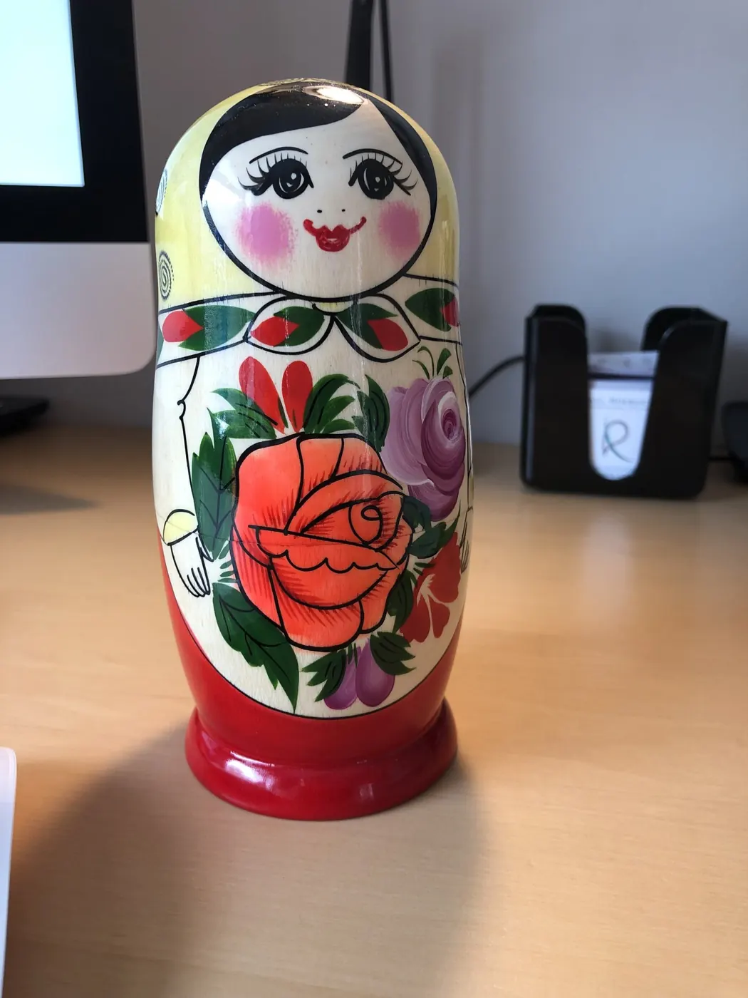 A painted Russian matryoshka doll on a desk, used in inner child therapy